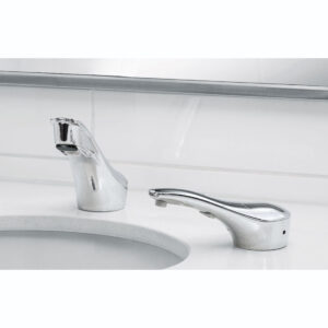 Chrome automatic faucet on white countertop beside a sink with tiled wall background.