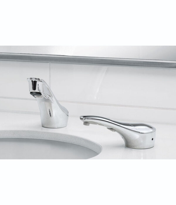 Chrome automatic faucet on white countertop beside a sink with tiled wall background.