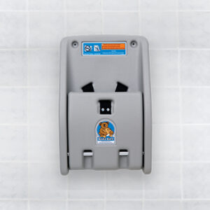 Gray koala-themed baby changing station on tiled wall with safety instructions at the top.