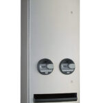 Metal vending machine with two "FREE" knobs and an item dispensing slot.