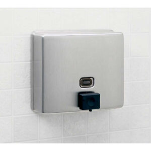 Stainless steel soap dispenser with sensor on tiled bathroom wall.