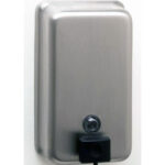 Wall-mounted stainless steel soap dispenser with push button and black nozzle.