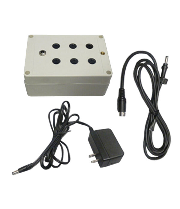 White electronic box with round openings, includes plug adapter and connector cable.