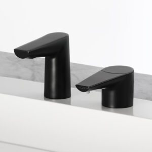 Two modern black faucets on white surface with gray marble background.