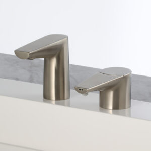 Modern brushed steel faucets on bathroom countertop with sleek, minimalist design.