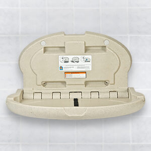 Wall-mounted foldable baby changing station with instructions on a tiled background.