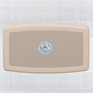 Wall-mounted baby changing station with koala logo on tiled wall.