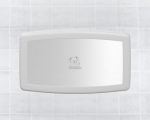 Wall-mounted horizontal baby changing station with central logo on tiled surface.