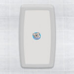 White baby changing station on tiled wall with koala illustration labeled "Koala Kare".