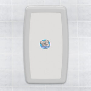 White baby changing station on tiled wall with koala illustration labeled "Koala Kare".