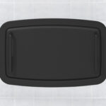Black plastic rectangular lid with handles on a tiled surface.