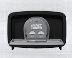Wall-mounted baby changing station with closed lid and safety strap against tiled background.