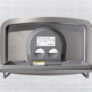 Wall-mounted stainless steel baby changing station with fold-down tray and instructions.