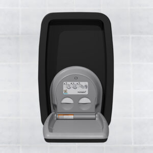 Wall-mounted baby changing station with black frame and gray surface, white tiled background.