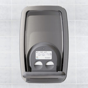 Stainless steel hand dryer on tiled wall with circular buttons and instructions above.