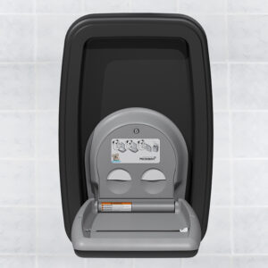 Baby changing station with Microban, grey and black, mounted on a tiled wall with instructions.
