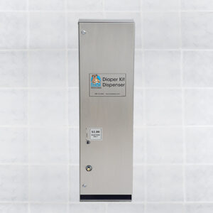 Stainless steel diaper kit dispenser on tile wall with payment slot and purchase instructions.