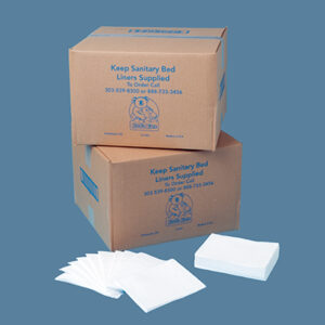 Two stacked boxes with unfolded white sanitary bed liners displayed in front.